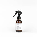 Brown spray bottle with black nozzle on a white background