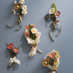 Set of felt flower bouquets and ribbons on a gray background