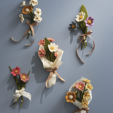 Set of felt flower bouquets and ribbons on a gray background