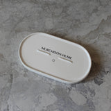 Underside of Murchison-Hume tray on a gray stone surface