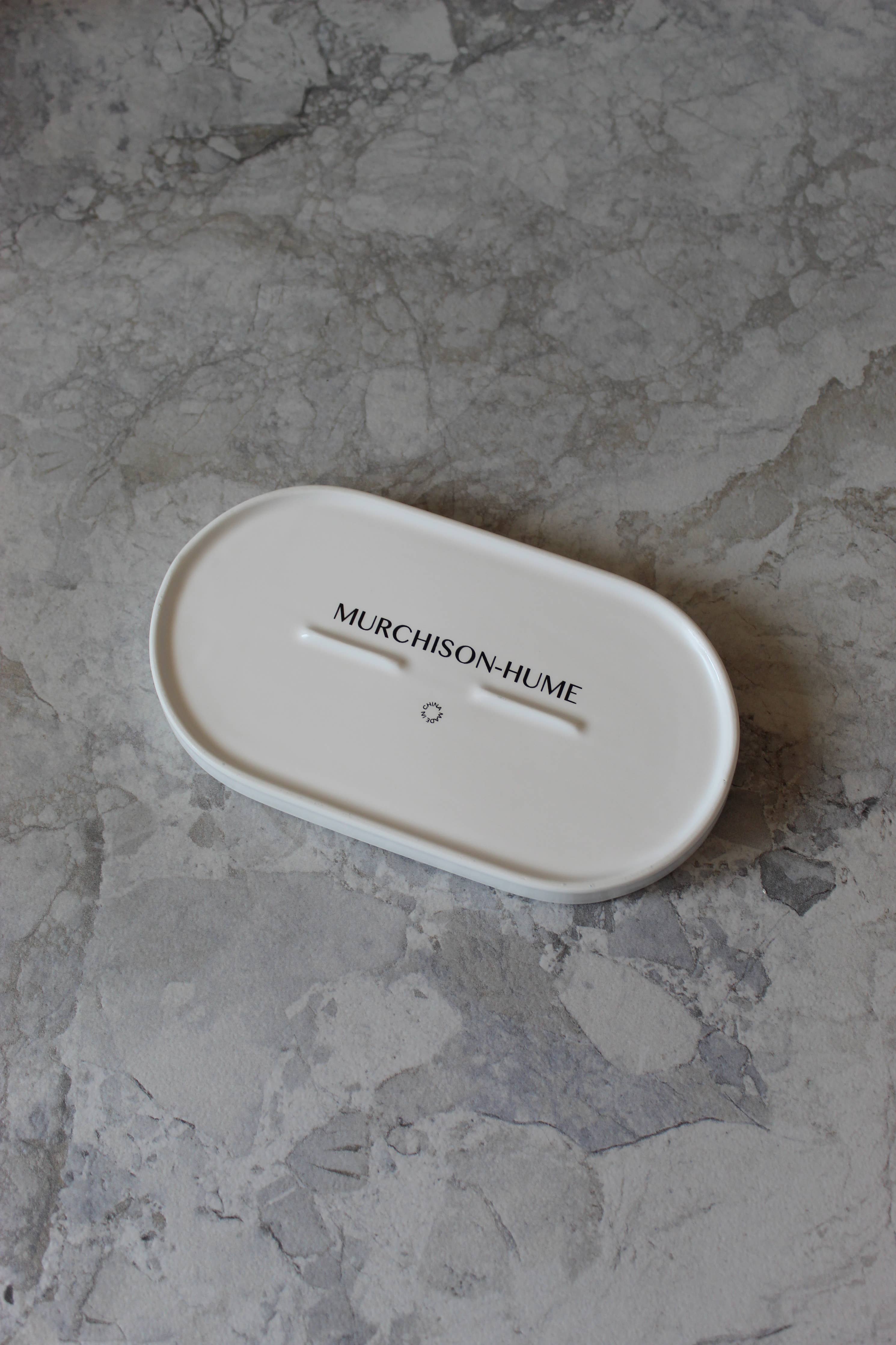 Underside of Murchison-Hume tray on a gray stone surface