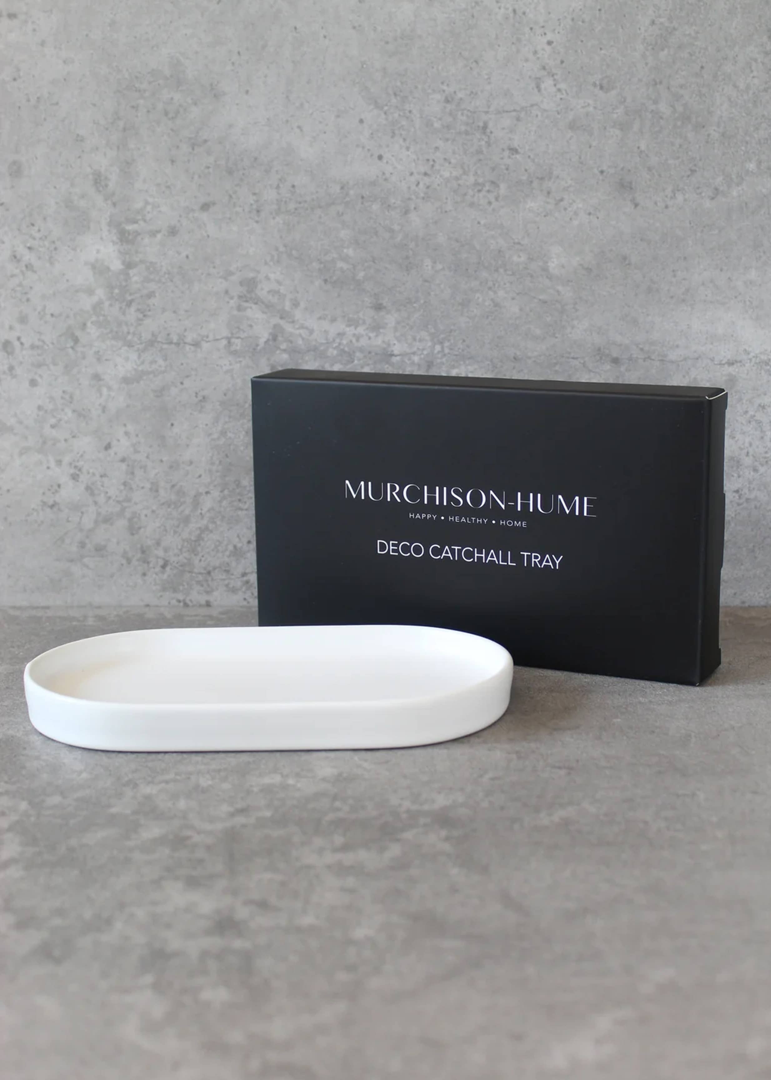White catchall tray in front of a black Murchison-Hume box on a gray surface