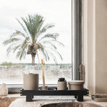 black bon tray with various containers by bathroom sink