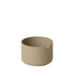 Beige ceramic pot with notch cutout on a white background