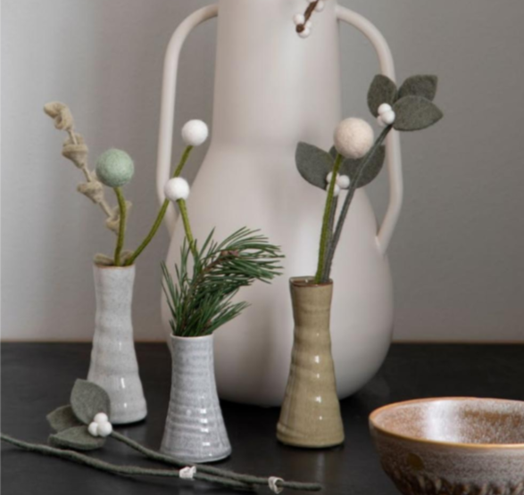 green and white flower stems in small vases