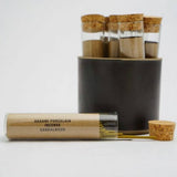 Set of glass test tubes with cork lids on a white background