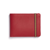 Red rectangular leather wallet with light brown elastic strap around one end.