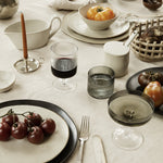 grey rippled glass drinkware with white ceramic plates on table 